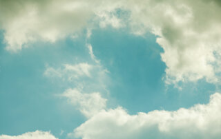 wispy white clouds on a blue sky, representing march weather patterns