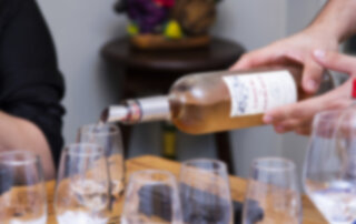 someone pouring rosé wine into glasses during a private tasting in temecula.