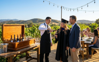 attentive temecula graduation wine service where a server pours red wine for a smiling graduate.
